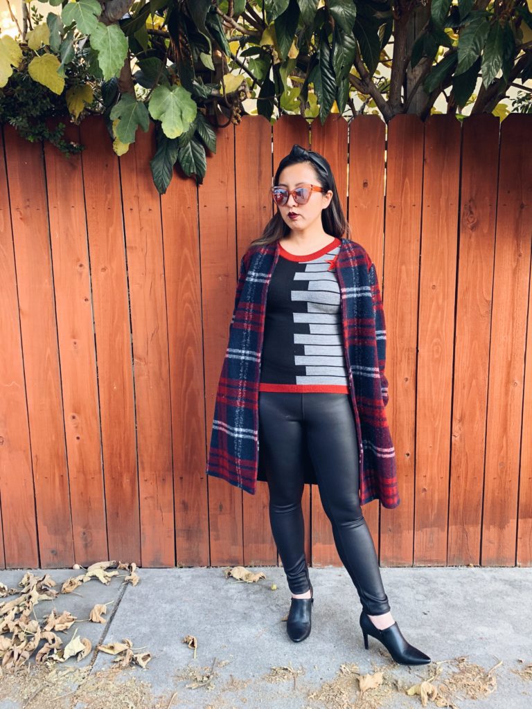 Alice wearing an oversize coat over a Winter Soldier top and pleather leggings. Red sunglasses.