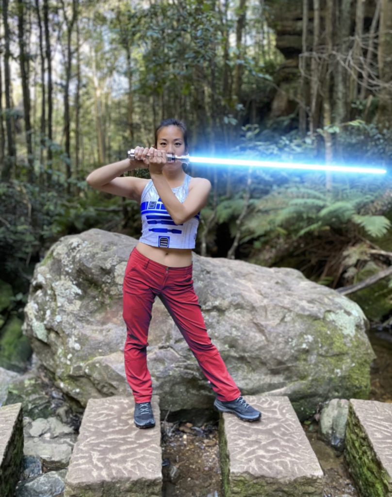 Posing with lightsaber in forest